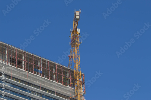 A crane in a construction work. Empty copy space for Editor's text