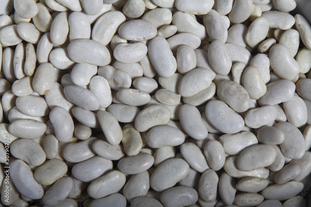 Close-up of lots of white beans, also called navy bean, haricot or pearl haricot in a grocery store Close-up of lots of white beans, also called navy bean, haricot or pearl haricot in a grocery store