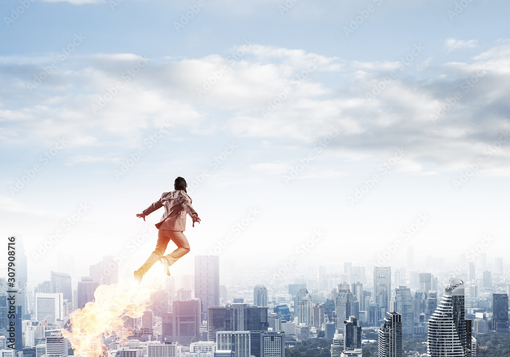 Businessman in suit and aviator hat flying in sky Businessman in suit and aviator hat flying in sky