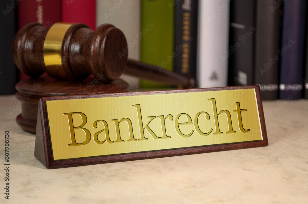 Golden sign with gavel and law book on a desk with the german word for banking law - bankrecht Golden sign with gavel and law book on a desk with the german word for banking law - bankrecht