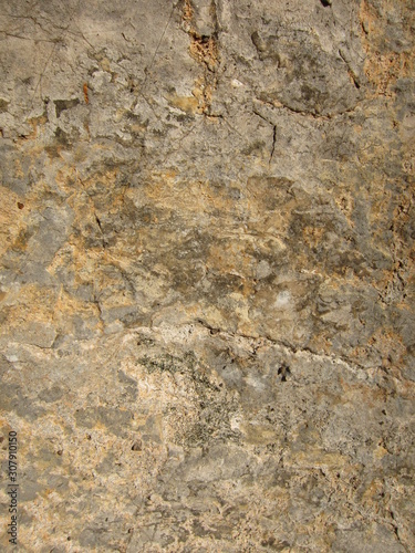 Texture of a sedimentary limestone rock with cracks