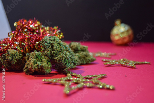 dried cannabis flowers with christmas decorations to celebrate the new year