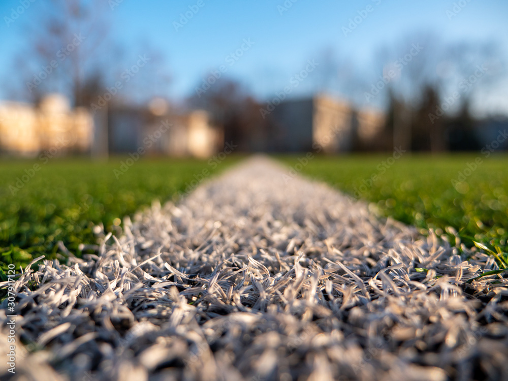 Close shot of a white line on a football field
