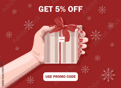 Woman hands holding christmas red gift box with ribbon. Snowflakes on backgro...