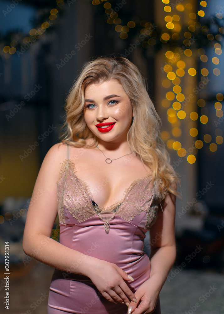 Young beautiful blonde with red lipstick in a pink dress Young beautiful blonde with red lipstick in a pink dress