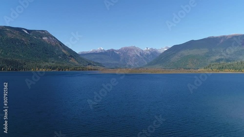 Wallpaper Mural Drone, aerial, rising, wide shot of a lake with two hillsides framing a snowy mountain. Torontodigital.ca