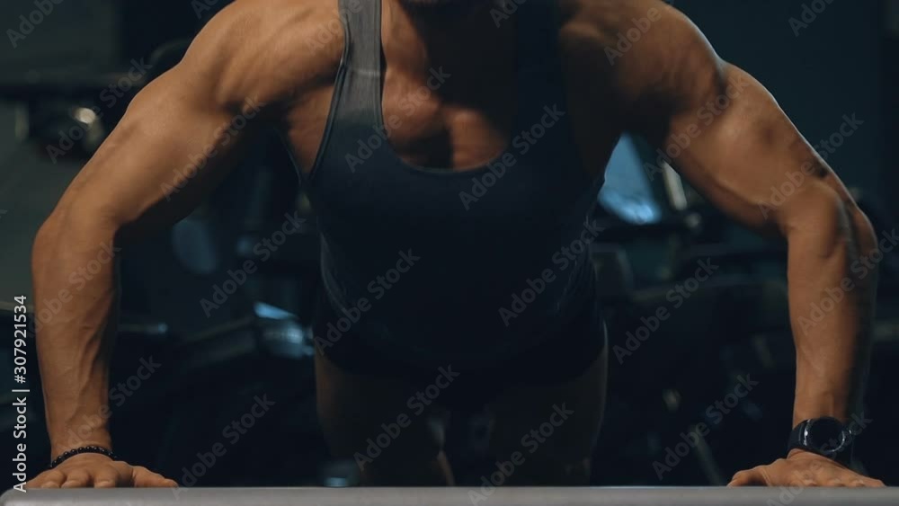 muscular bodybuilder fitness men pumping up muscles push-ups workout fitness exercises and bodybuilding concept background - Handsome athletic men doing bars exercises in gym naked tors