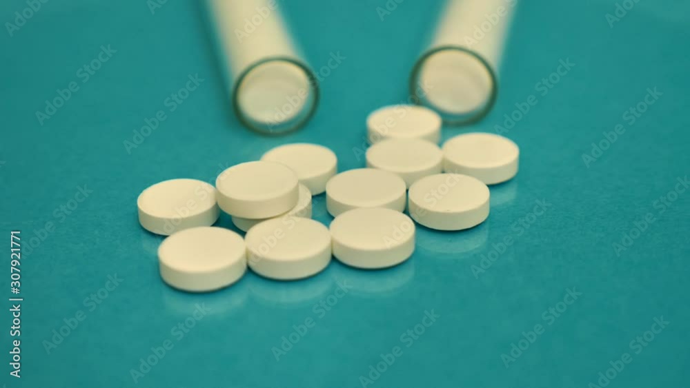 Generic drugs on table top, camera moves slowly accross spilled pills and into the bottle. Generic drugs on table top, camera moves slowly accross spilled pills and into the bottle.
