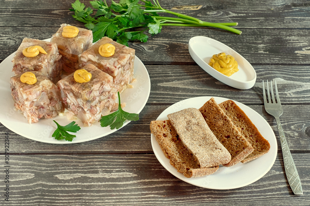 aspic with mustard, bread and parsley on a dark wooden background aspic with mustard, bread and parsley on a dark wooden background