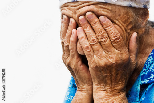 Fototapet Crying old grandmother cover her sad face