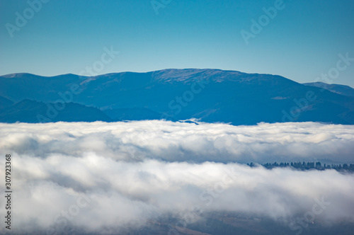 The view from the heights of the mountains and forests covered by fog