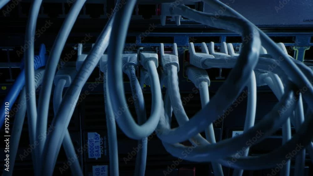 Close-up Macro Shot: Ethernet Cables Connected to Router Ports. Telecommunications: RJ45 Device Connectors Plugged into Modem Hubs. Immersive POV First Person Zoom Out Camera Moving Between Cables Close-up Macro Shot: Ethernet Cables Connected to Router Ports. Telecommunications: RJ45 Device Connectors Plugged into Modem Hubs. Immersive POV First Person Zoom Out Camera Moving Between Cables