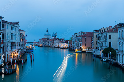 Illuminated boat creates light trails in the Grand Canal of Venice.