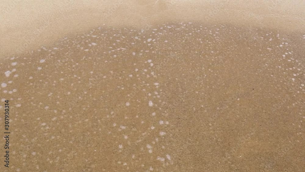 Handwritten inscription 70% on a sandy sea beach is washed by the sea wave with foam on a summer sunny day. Disappearing statistics and percent writing Handwritten inscription 70% on a sandy sea beach is washed by the sea wave with foam on a summer sunny day. Disappearing statistics and percent writing