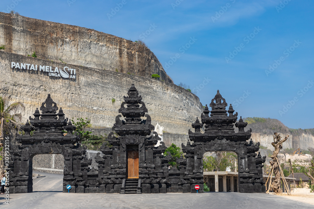 BALI / INDONESIA - OCTOBER 25, 2019: Traditional hindu gate to enter to Melasti beach in Bali BALI / INDONESIA - OCTOBER 25, 2019: Traditional hindu gate to enter to Melasti beach in Bali