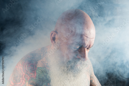 older man with beard smoking