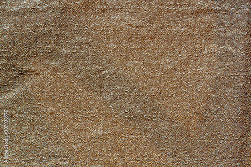 The texture of the fabric. Brown fabric with a crumpled surface. Copy space