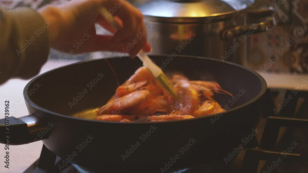 Mixed large red shrimps are fried in hot boiled oil on pan, close-up. Shrimps Prawns are fried in a large frying pan, the chef prepares the prepared shrimp. Mixed large red shrimps are fried in hot boiled oil on pan, close-up. Shrimps Prawns are fried in a large frying pan, the chef prepares the prepared shrimp.