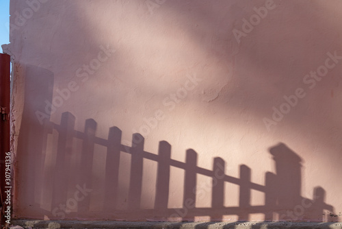 Old house pink wall with sun and shadows