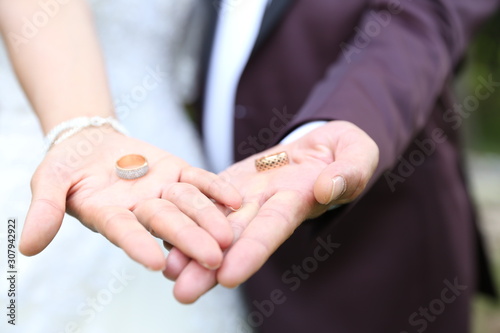 two wedding rings in the hands of the newlyweds gold wedding rings wedding rings of precious metal on the hands of a man and a woman wedding ceremony. 