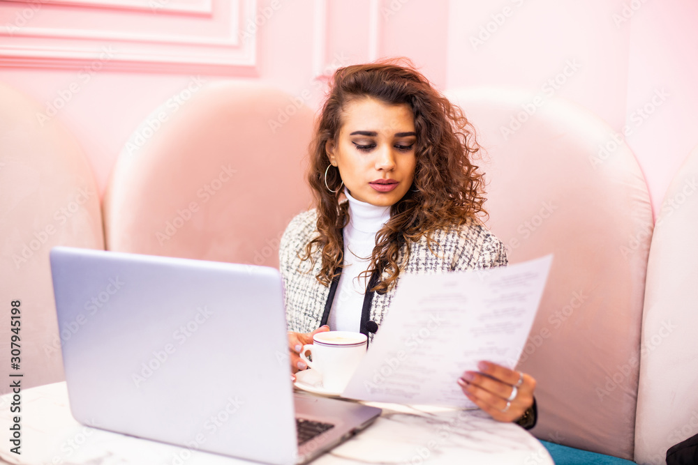 Beautiful young woman working on laptop and smiling while sitting outdoors Beautiful young woman working on laptop and smiling while sitting outdoors