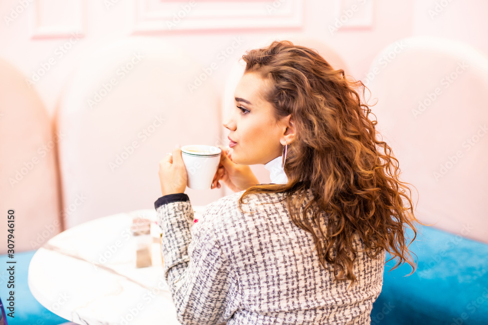 Young pretty woman in a cafe drinking coffee Young pretty woman in a cafe drinking coffee