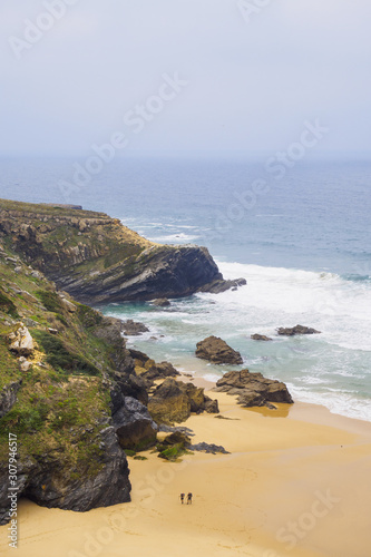 High angle view of two hikers hiking along the coast, Rota Vicentina, Portugal