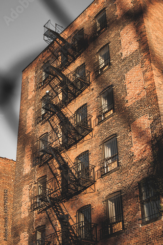 New York, December, 2017, Brick building in Brooklyn through a fence