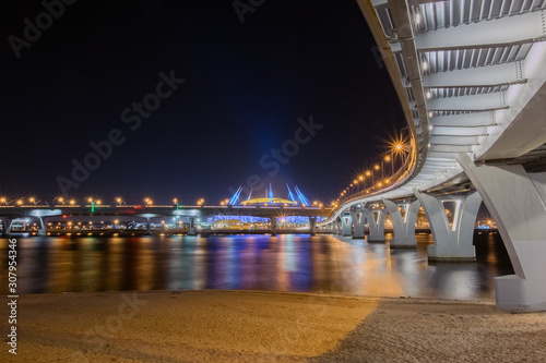 The new Zenit arena stadium, where the 2018 FIFA world Cup was held. Night view from under the pedestrian bridge intertwined with the bridges of the ZSD highway photo