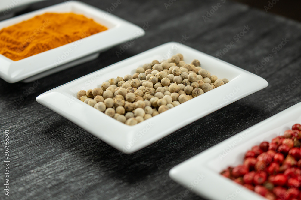 White pepper. Colorful spices in white bowls Seasonings for cooking. Natural Herbs & Spices. White pepper. Colorful spices in white bowls Seasonings for cooking. Natural Herbs & Spices.