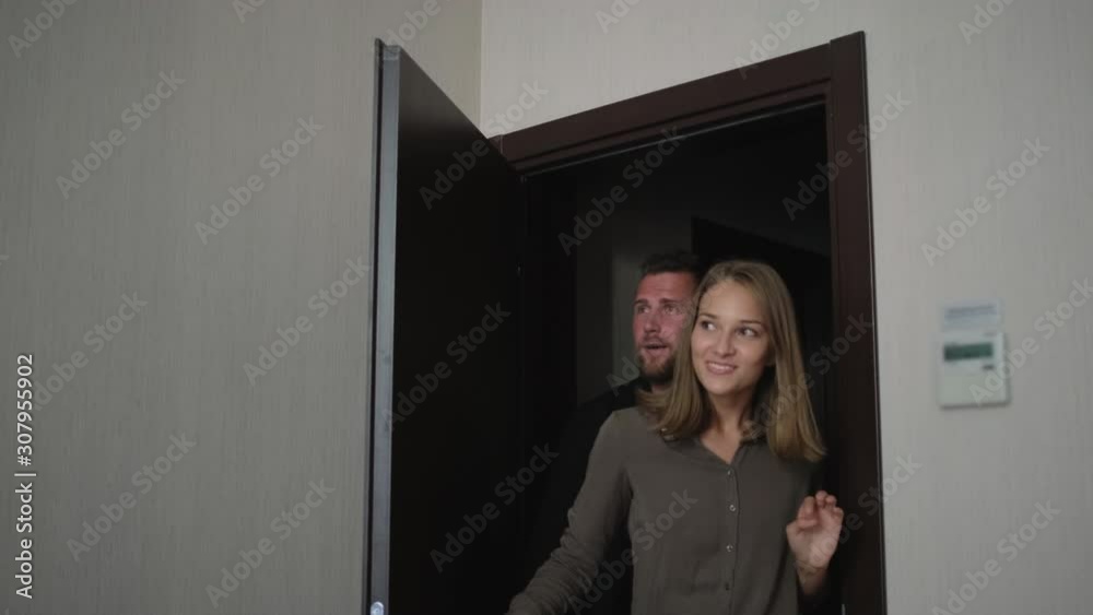 Family couple is happy to walk into the new apartment