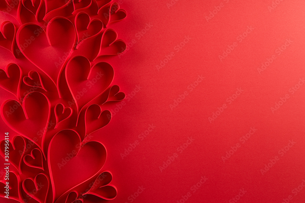 Red paper hearts on red paper background. Love and Valentine's day concept. - obrazy, fototapety, plakaty 