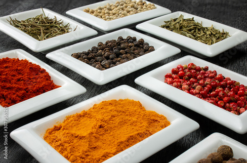 Colorful spices in white bowls Seasonings for cooking. Natural Herbs & Spices.