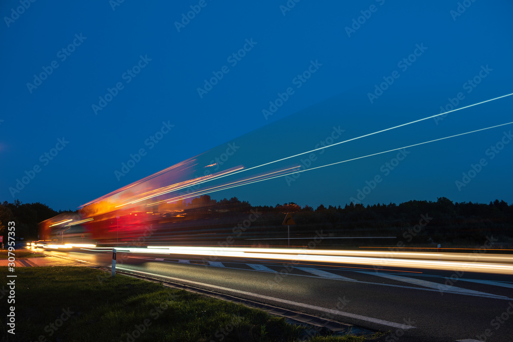 Truck light trails on highway. Art image . Long exposure photo taken on a highway