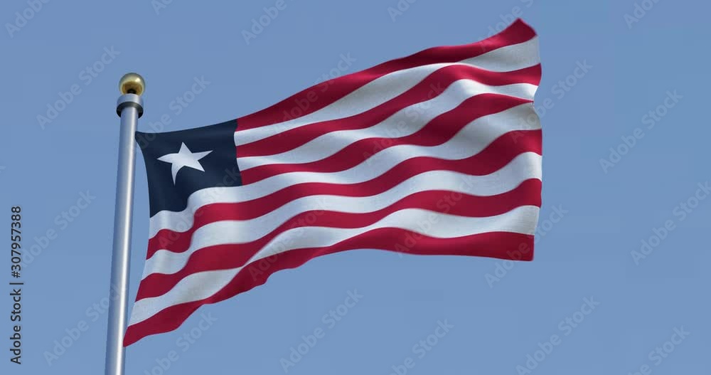 Flag of Liberia blowing in the wind in front of a blue sky