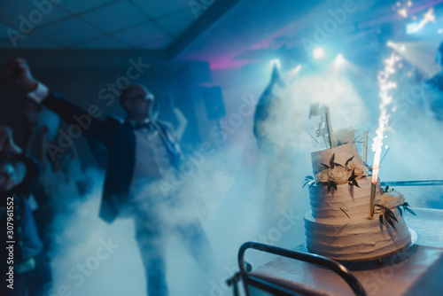 Delicious Wedding Cake at the party. Smoke and fire effects. © Andrzej Wilusz