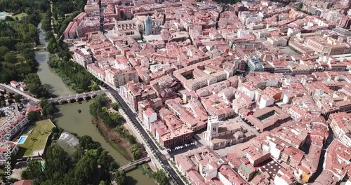 View from drone of reddish roofs of residential buildings of Spanish city of Palencia on bank of Carrion river  photo