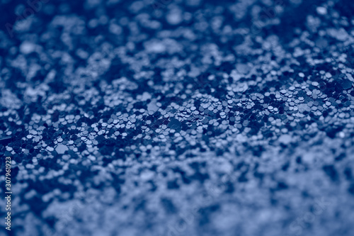 Sparkle background in blue color. Magical macro shot of glitter.