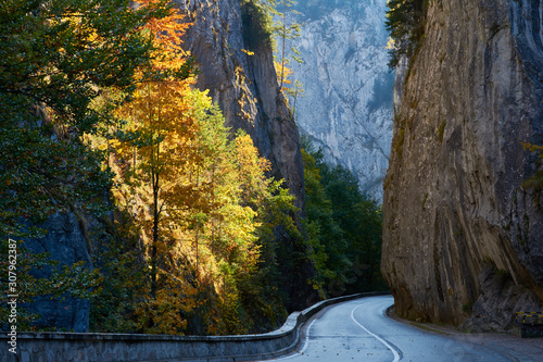 Scenic spot Bicaz Gorge in Carpathian Mountains, Romania. Sunny autumn morning. The road among the rocks.