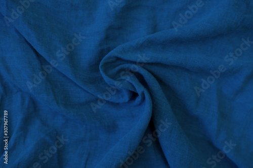 Crumpled blue fabric texture close up. Trendy tone of 2020 classic blue color