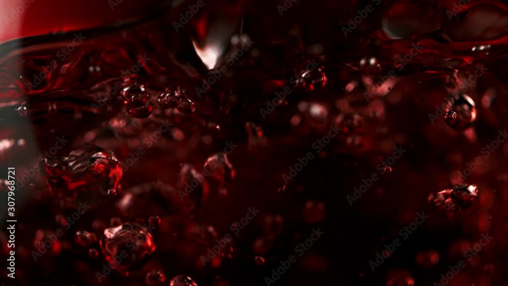 Super slow motion of pouring red wine in macro shot. Filmed on high speed cinema camera, 1000 fps