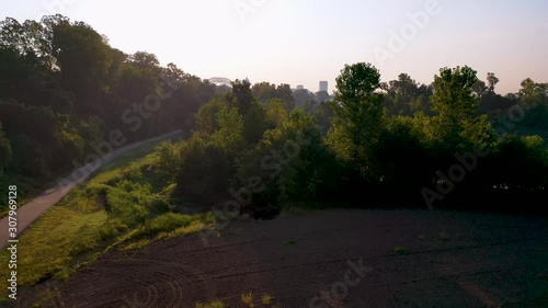 Rising aerial skyline and business district Memphis Tennessee across the Mississippi River with Hernando de Soto Bridge foreground. photo