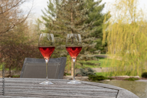 Two glasses of rose wine on a patio table