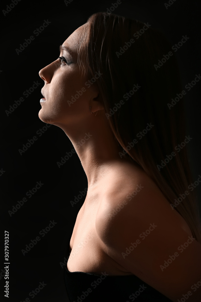 Fashionable young woman on dark background Fashionable young woman on dark background