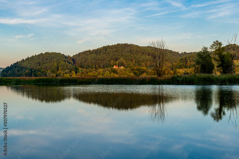 Landscape in autumn with by the River Dunajec and blue sky, Poland October 2019