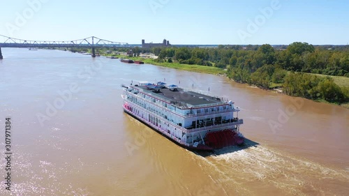 Beautiful aerial shot of a paddlewheel steamboat luxury cruise ship on the Mississippi River near West Helena, Arkansas.