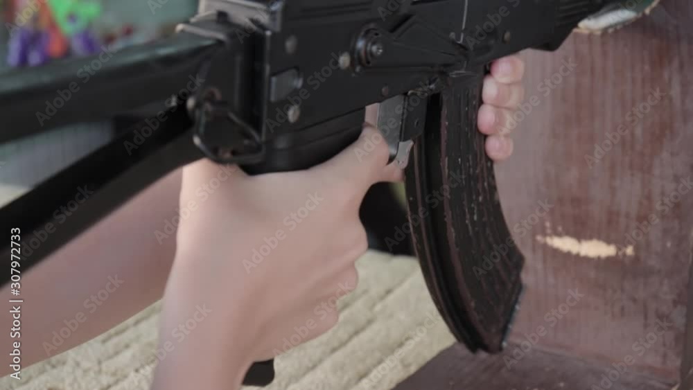 Caucasian teenage boy aiming with pneumatic rifle in shooting gallery, range Caucasian teenage boy aiming with pneumatic rifle in shooting gallery, range