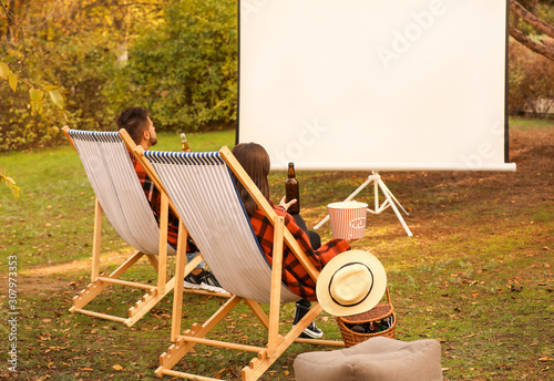 Young couple watching movie...