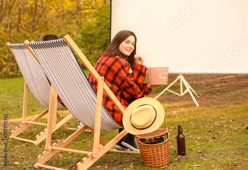 Young woman watching movie ...