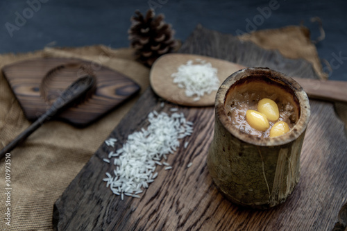 Sticky Rice Cooked with Coconut milk (Khao lam) or Glutinous rice roasted in bamboo joints on wooden, Thai dessert concept.
